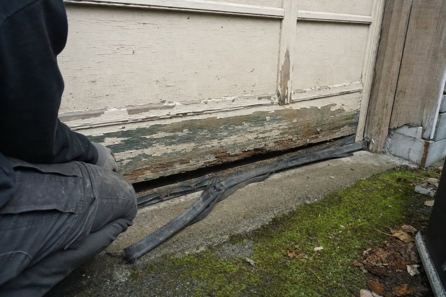 Rotting bottom panel of an old wood garage door