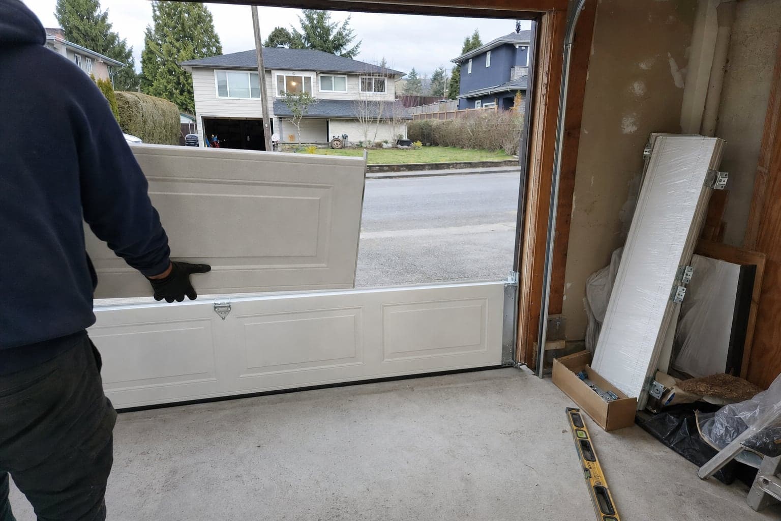 Installing the sections of a new garage door