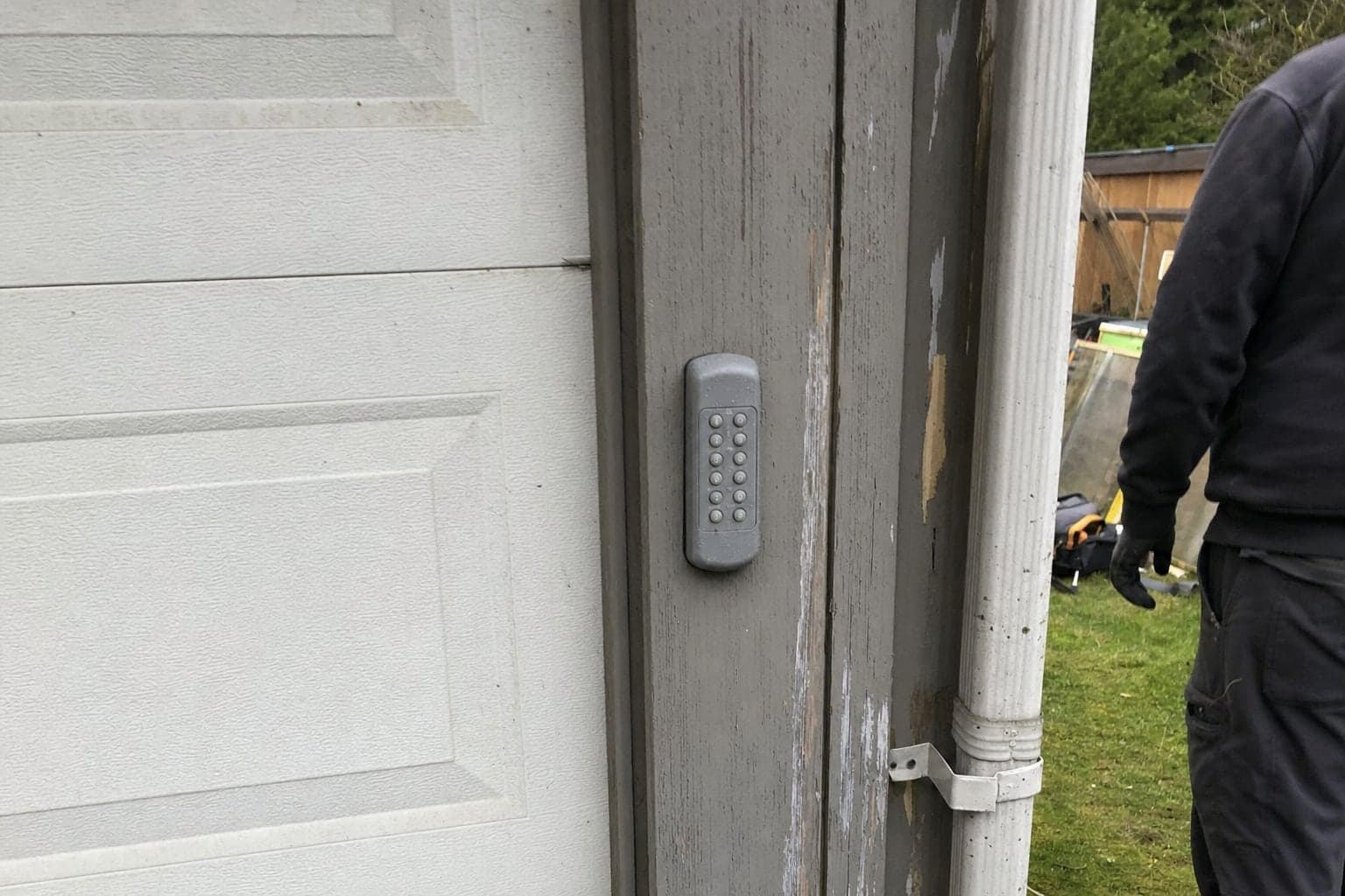 Outdoor keypad beside a garage door
